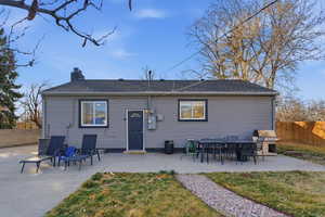 Back of property with a patio, outdoor dining space, and roof with shingles