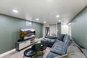 Living area featuring carpet and recessed lighting