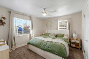 Owners bedroom with carpet flooring and ceiling fan
