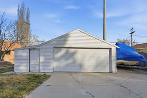 View of  2-car detached garage with small work/storage space