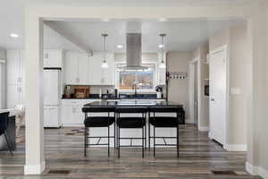 Open Kitchen featuring granite countertops, pendants, and large island range hood