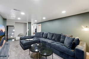 Carpeted living area with recessed lighting