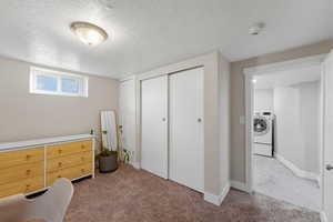 Carpeted bedroom featuring a closet, a textured ceiling