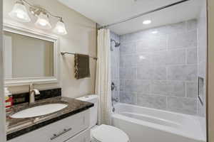 Bathroom with shower / bath combo, vanity, and recessed lighting