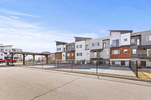 View of property's community with a tennis court and a residential view