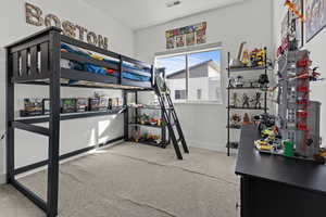 Bedroom featuring light colored carpet and baseboards