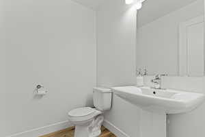 Bathroom with toilet and wood finished floors