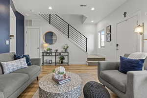 Living room with wood finished floors and recessed lighting