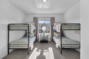 Carpeted bedroom featuring baseboards