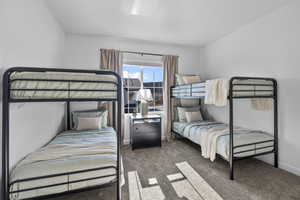 Carpeted bedroom featuring baseboards