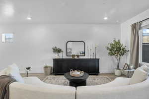 Living area with wood finished floors and baseboards
