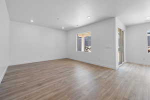 Unfurnished room with light wood-type flooring and recessed lighting