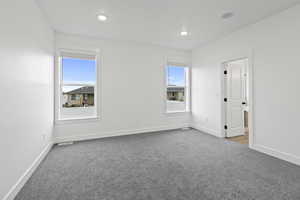 Spare room with light carpet and recessed lighting