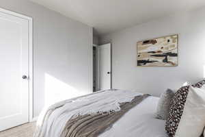 Bedroom featuring carpet and baseboards