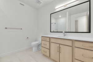 Full bath with vanity and a tile shower