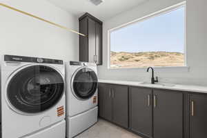 Laundry room featuring cabinet space, independent washer and dryer, and light tile patterned floors