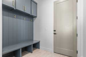 Mudroom with wood tiled floors and baseboards