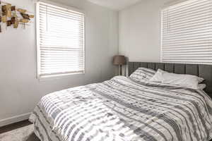 Bedroom with baseboards and wood finished floors