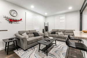 Living room with recessed lighting and wood finished floors