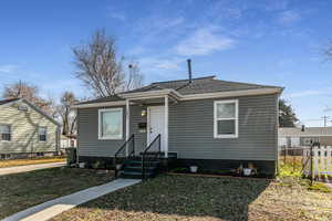 Bungalow-style house featuring roof with shingles