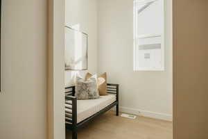 Living area with light wood-style flooring and baseboards