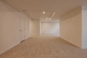 Unfurnished room featuring light colored carpet and recessed lighting