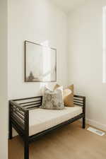 Sitting room with baseboards and light wood-style floors