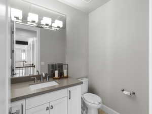 Half bath with vanity and toilet