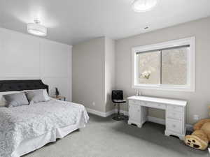 Bedroom featuring carpet floors and a desk