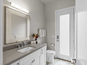 Half bath featuring vanity and toilet
