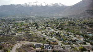 Aerial overview of property's location with nearby suburban area and a mountainous background