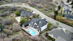 Aerial overview of property's location with nearby suburban area and a pool
