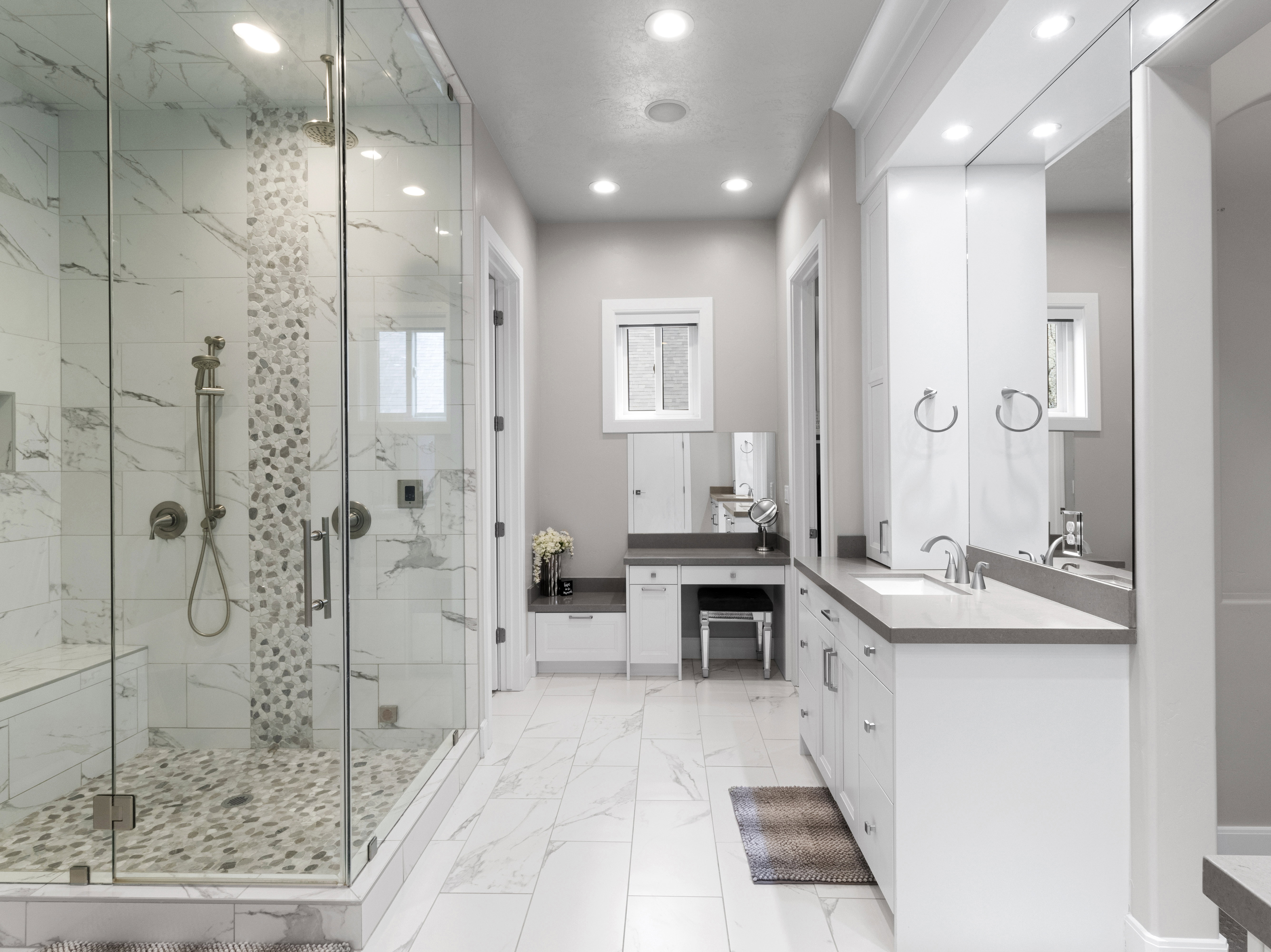 Full bath with vanity, a marble finish shower, recessed lighting, and light marble finish flooring