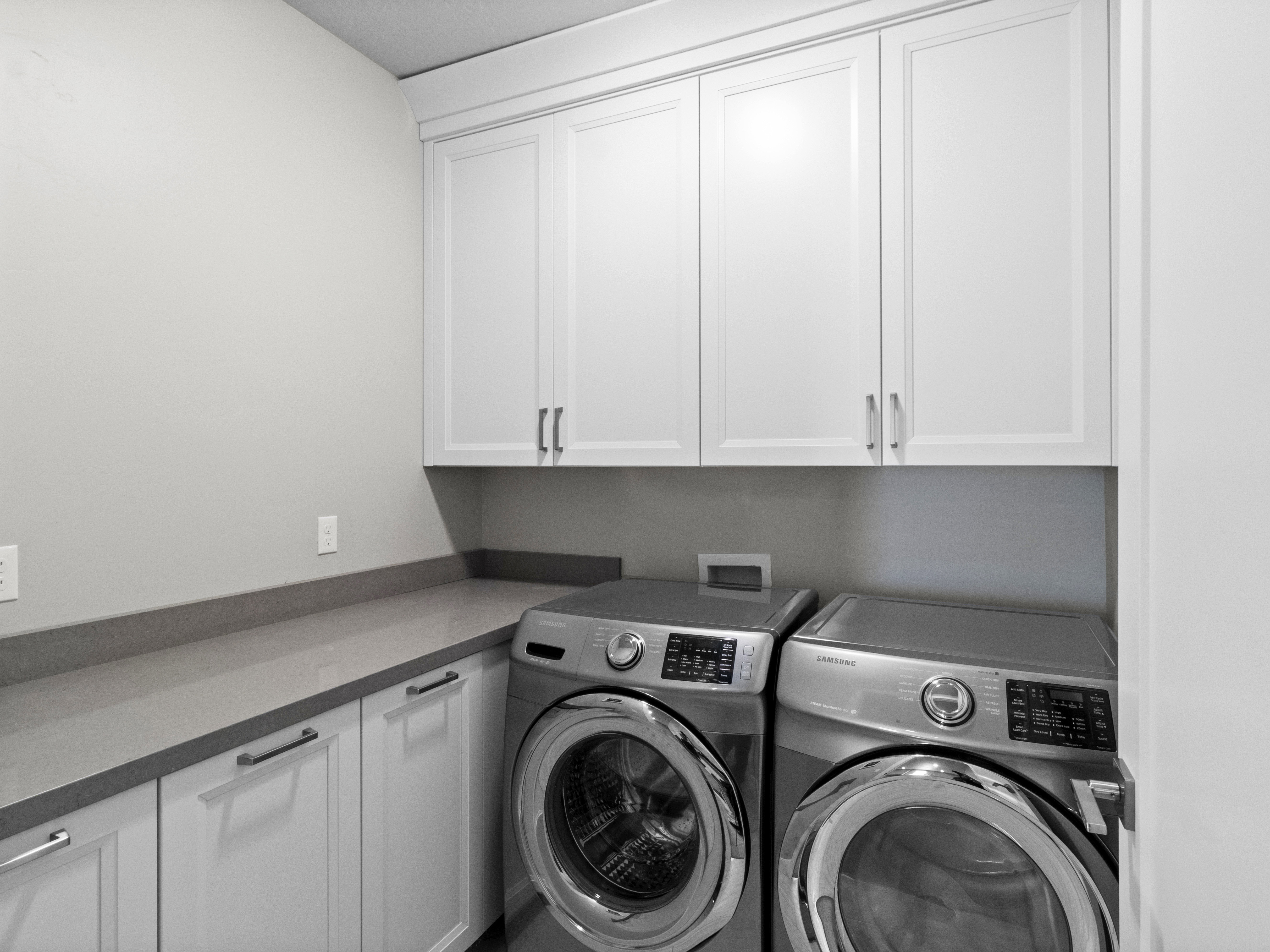 Laundry area with washer and dryer and cabinet space
