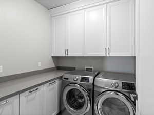 Laundry area with washer and dryer and cabinet space