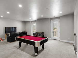 Playroom featuring light colored carpet, pool table, recessed lighting, and a textured ceiling