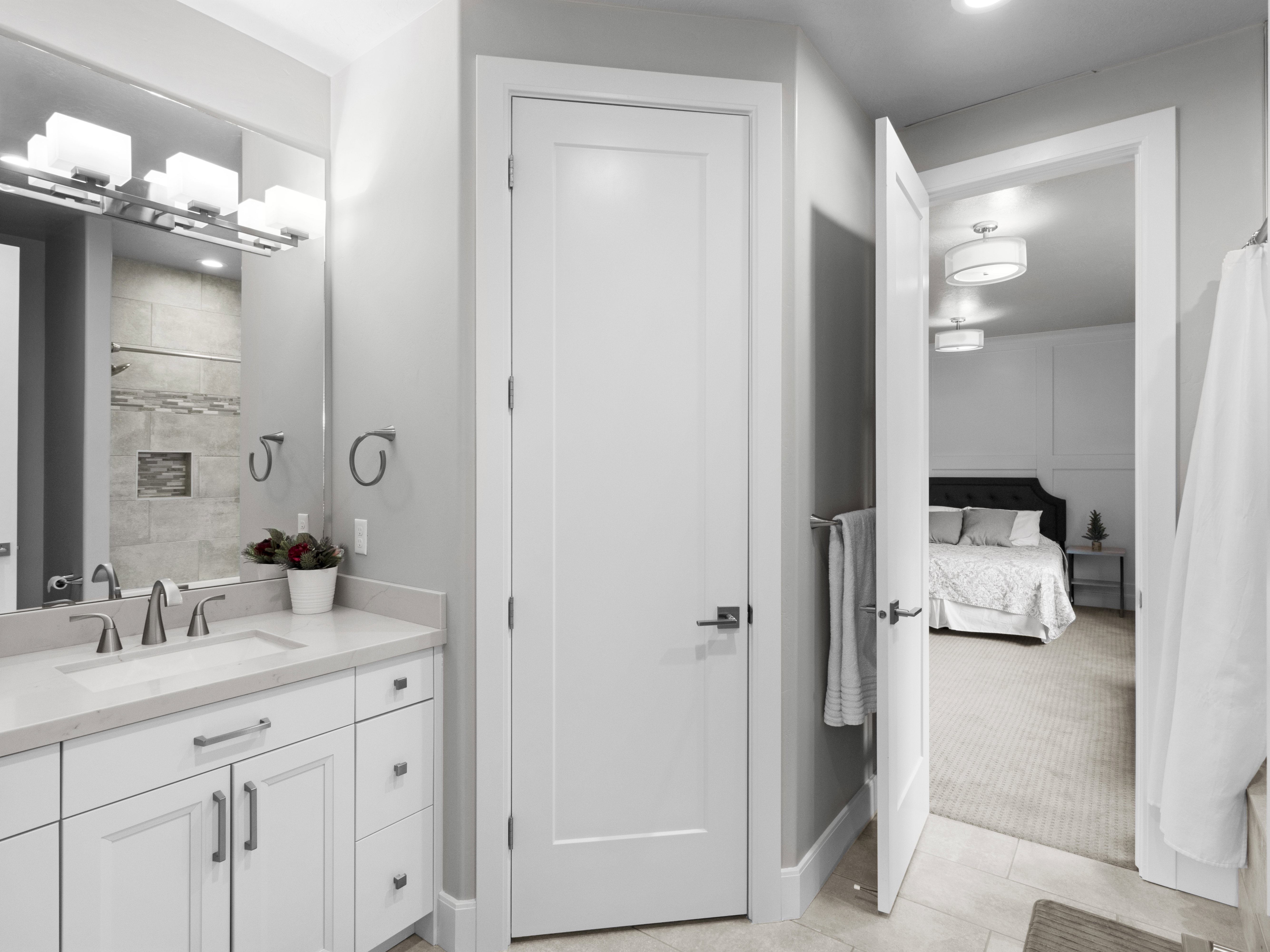 Ensuite bathroom with curtained shower, vanity, light tile patterned flooring, recessed lighting, and light colored carpet