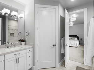 Ensuite bathroom with curtained shower, vanity, light tile patterned flooring, recessed lighting, and light colored carpet