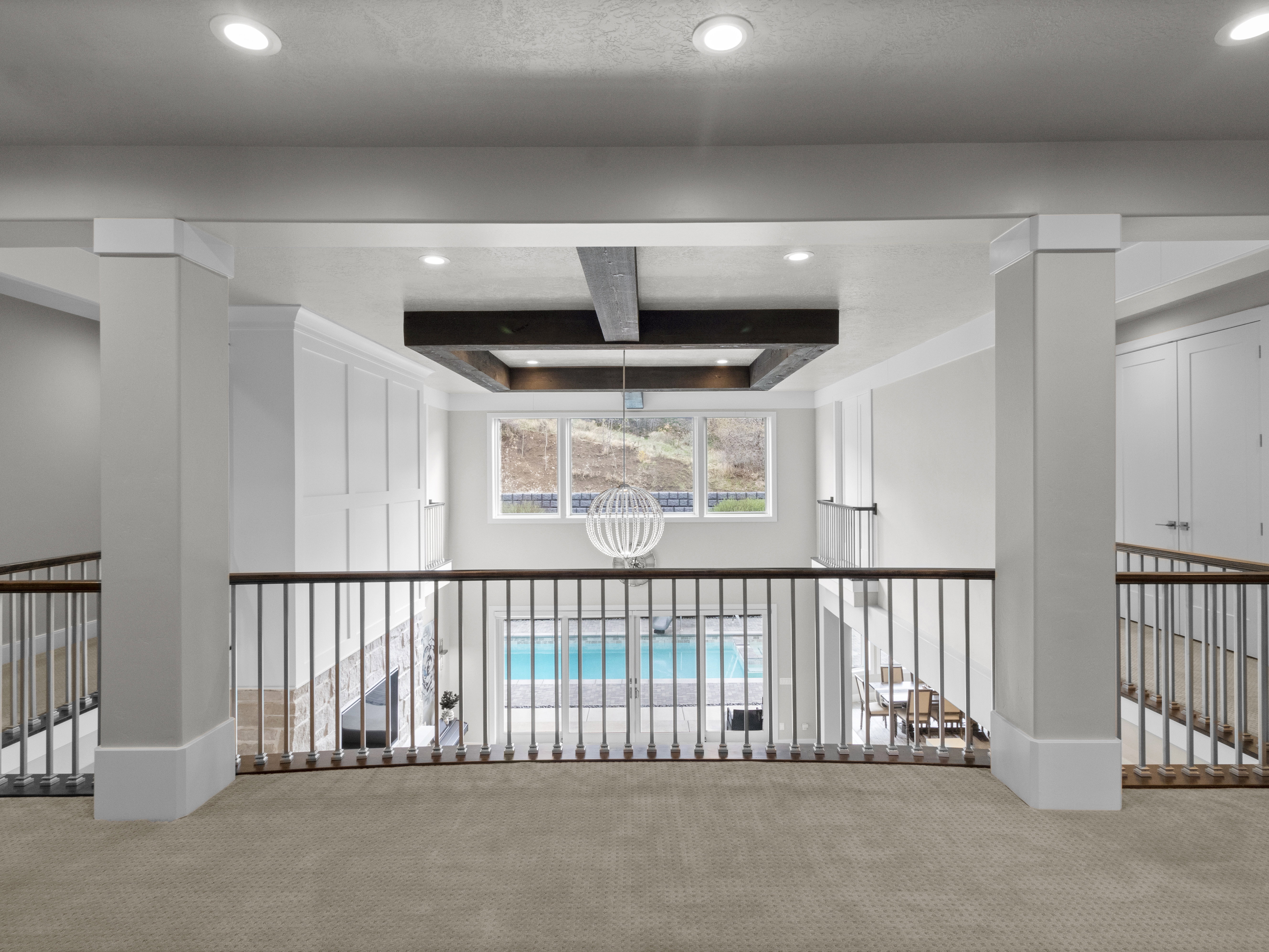 Hallway featuring carpet flooring, recessed lighting, a raised ceiling, and coffered ceiling