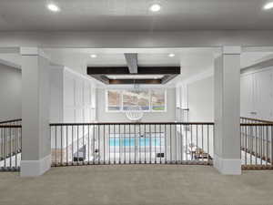 Hallway featuring carpet flooring, recessed lighting, a raised ceiling, and coffered ceiling
