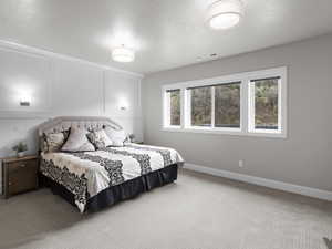 Bedroom with a decorative wall and carpet
