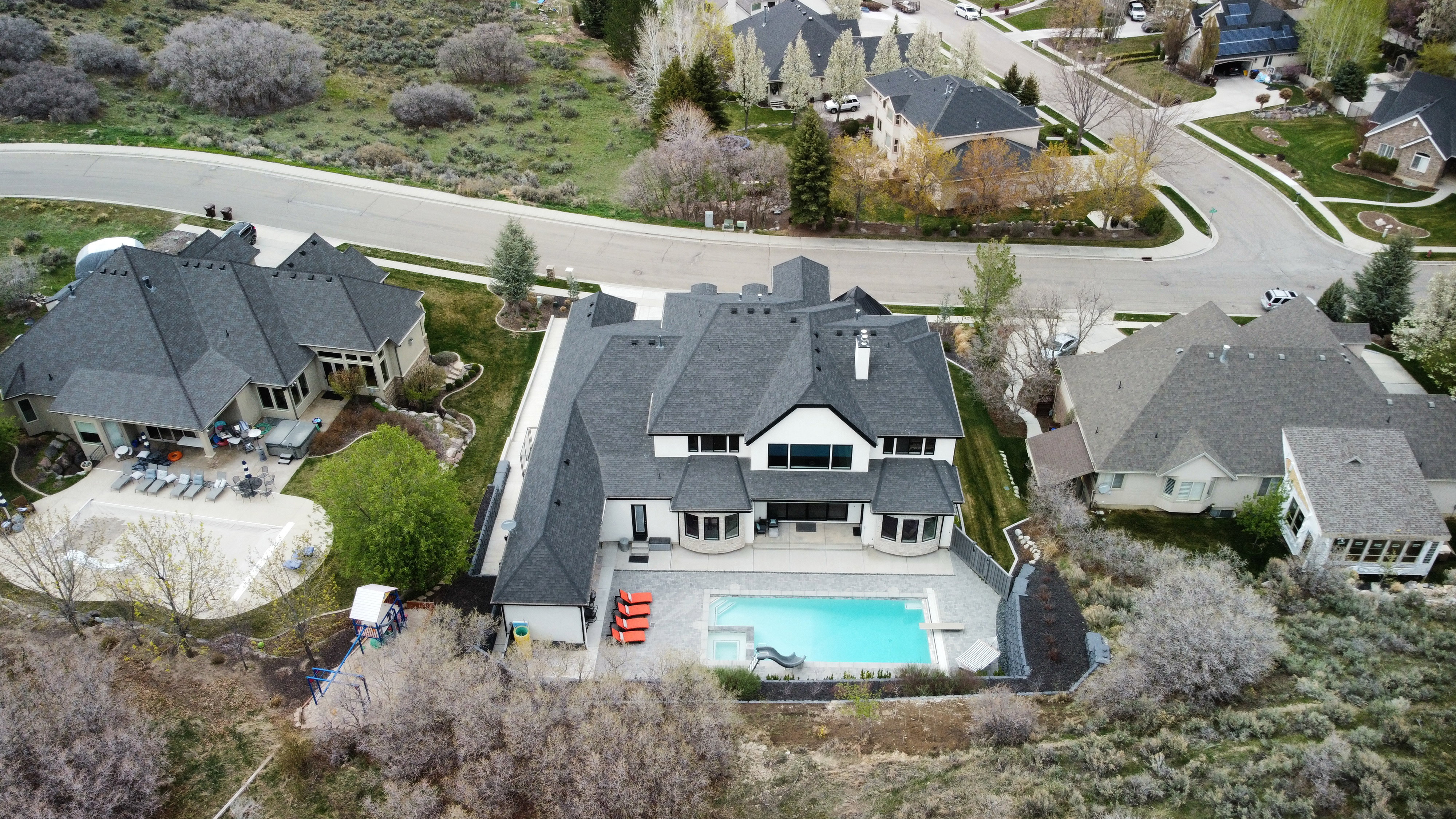 Aerial view of residential area featuring a pool area