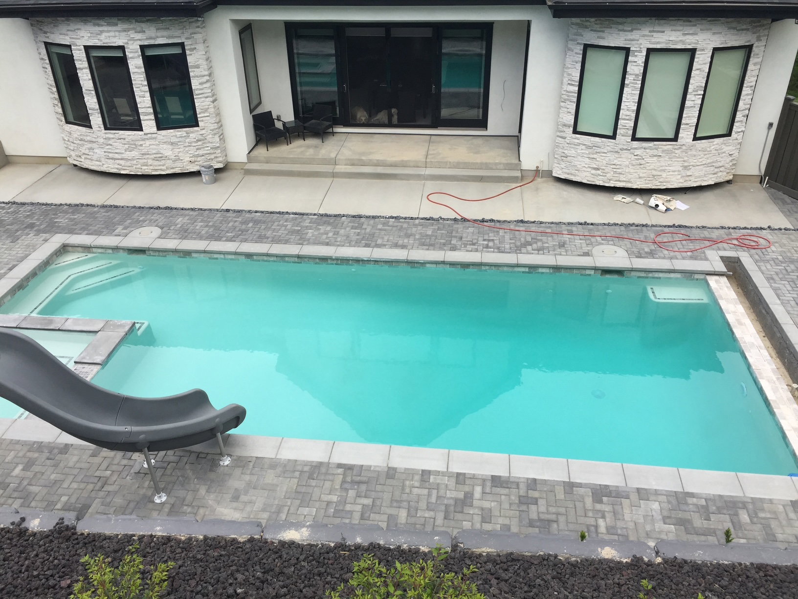 Swimming pool featuring a patio and a water slide