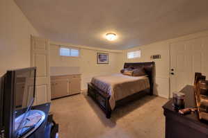 2nd Bedroom featuring light carpet and a wainscoted wall