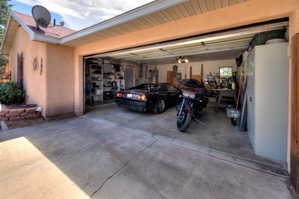 Garage with driveway and gas water heater