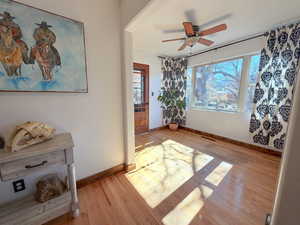 Unfurnished room with wood finished floors and a ceiling fan