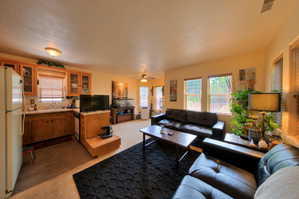 Apartment Living area featuring light carpet and ceiling fan