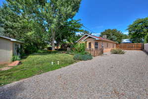 View of fenced backyard, veggie garden potential and additional parking.