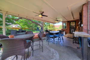 View of patio / terrace featuring outdoor dining area and a ceiling fan - Oasis in the city.
