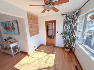 Entrance foyer featuring light wood-style floors and ceiling fan